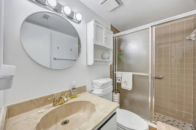 a bathroom with a sink toilet and shower
