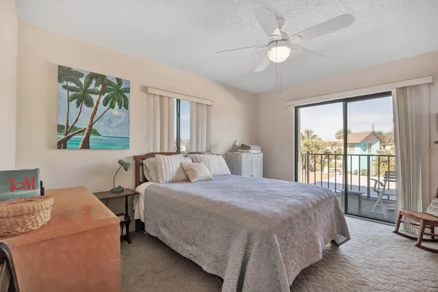 a bedroom with a bed a table and a chandelier