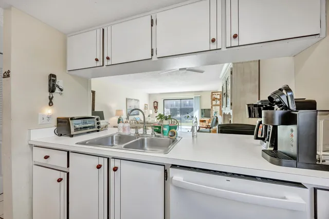a kitchen with appliances a sink and cabinets