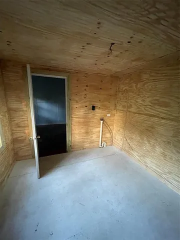 a view of empty room with a fireplace