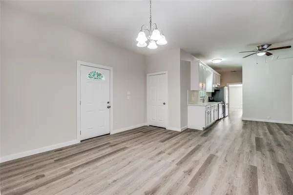 a view of a kitchen with wooden floor and a kitchen