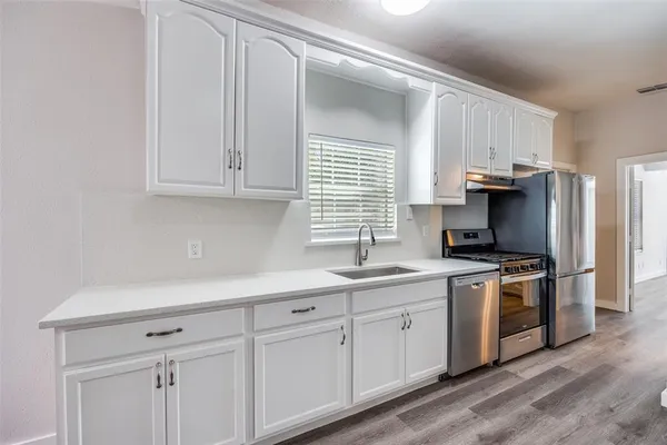 a kitchen with a sink dishwasher stove and refrigerator