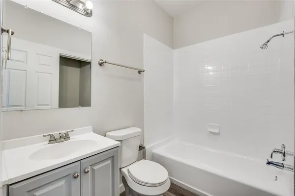 a bathroom with a sink toilet vanity and tub