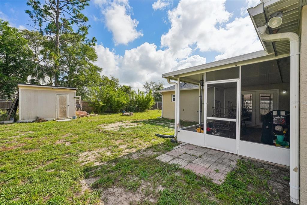 10303 Fordham Street Spring Hill, FL 34608 - Photo 23 of 25 a view of a house with backyard and garden