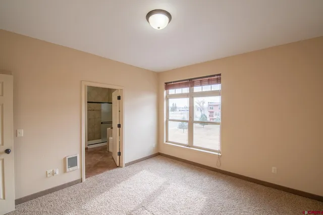 a bathroom with a granite countertop sink a toilet and shower