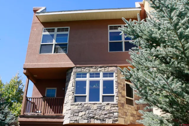 a front view of a building with a garden