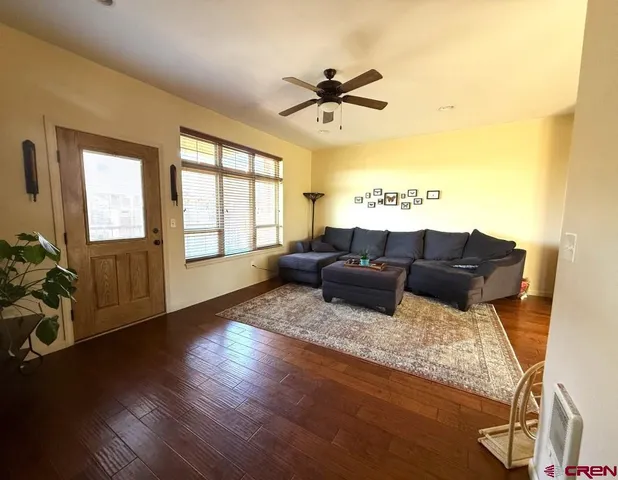 a living room with furniture window and wooden floor