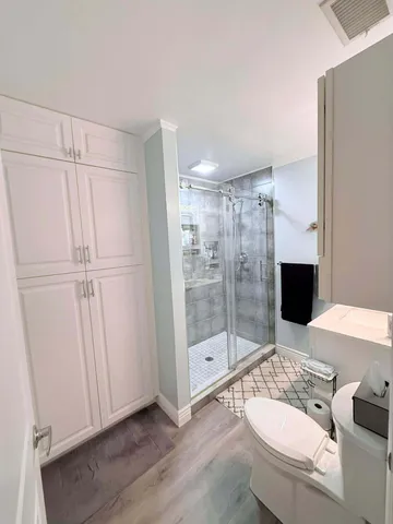 a bathroom with a sink toilet and shower