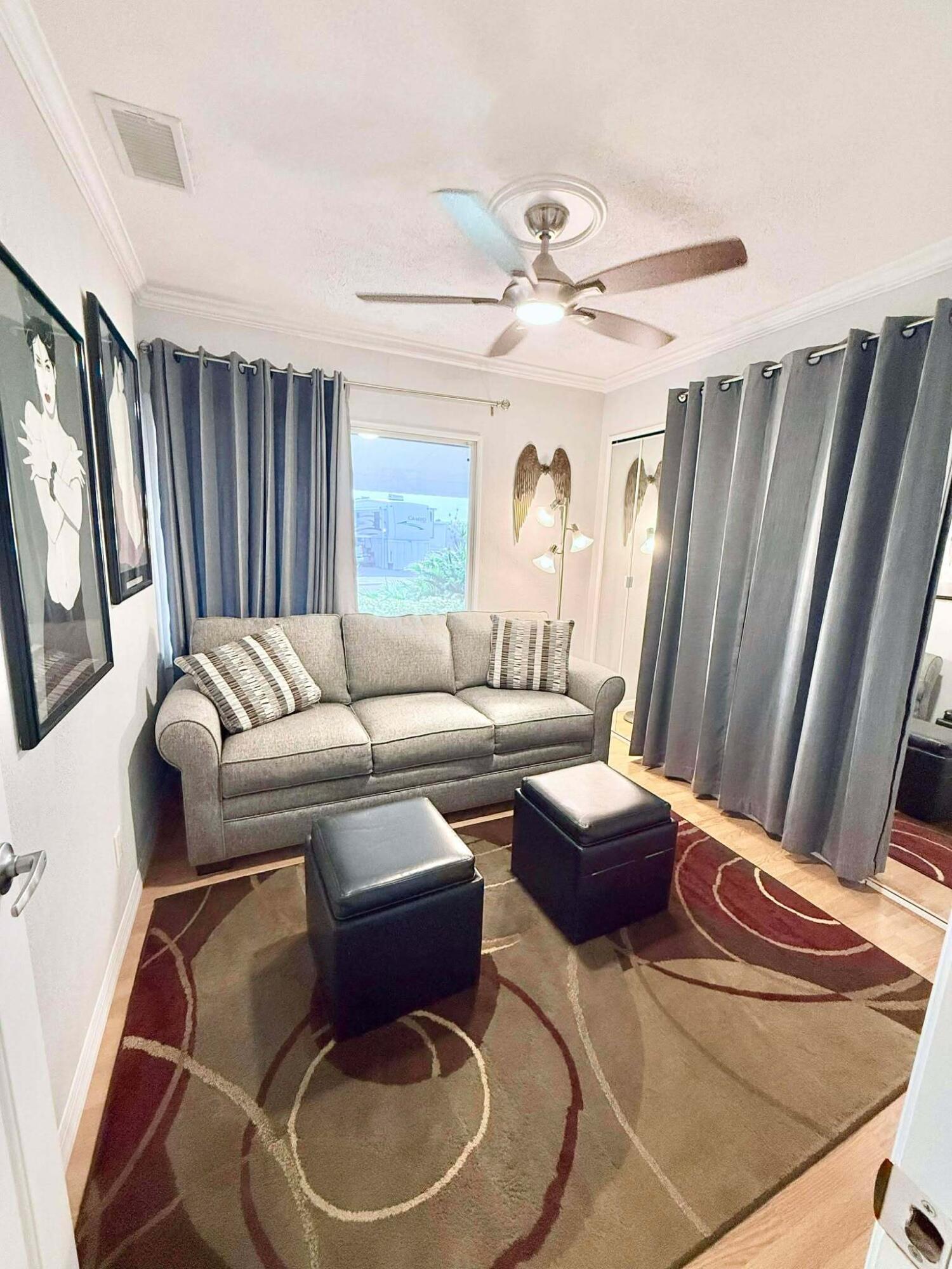 12321 Southeast 138th Avenue, Unit 216 Okeechobee, FL 34974 - Photo 16 of 34 a living room with furniture and a large window