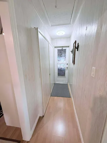 a view of a hallway with wooden floor