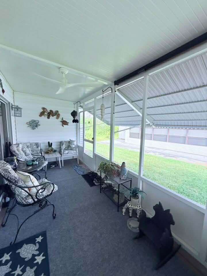12321 Southeast 138th Avenue, Unit 216 Okeechobee, FL 34974 - Photo 20 of 34 a living room with furniture and a large window