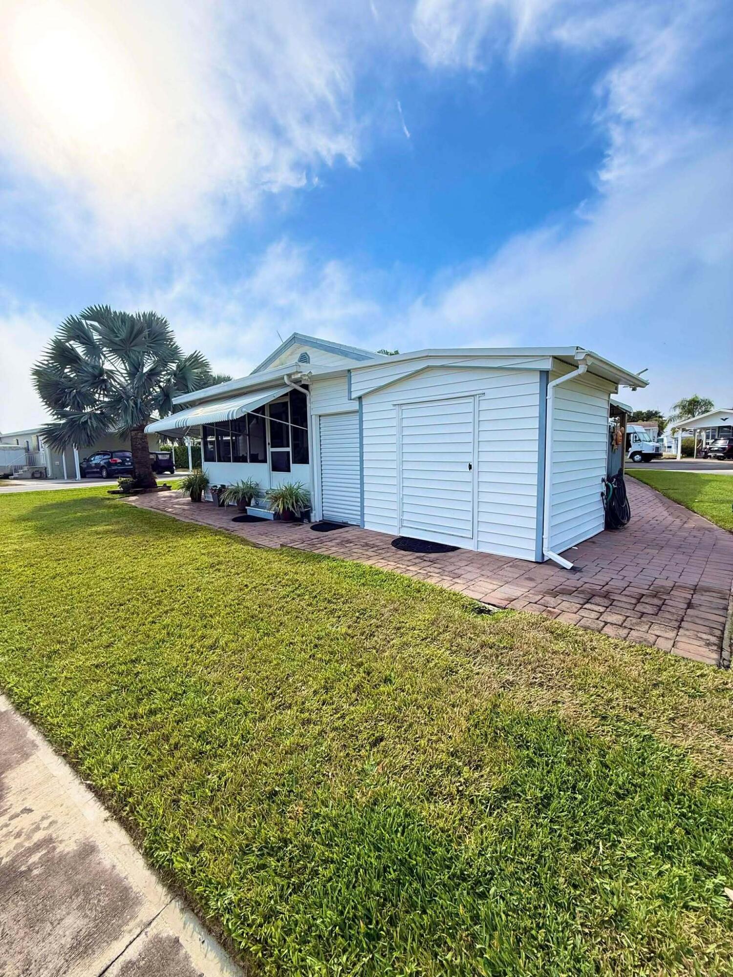 12321 Southeast 138th Avenue, Unit 216 Okeechobee, FL 34974 - Photo 25 of 34 a view of a house with a yard