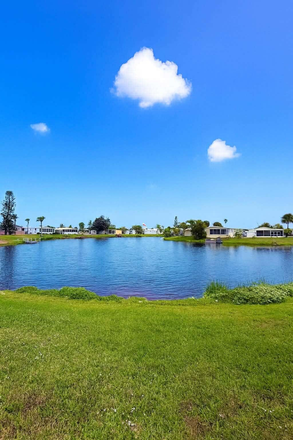 12321 Southeast 138th Avenue, Unit 216 Okeechobee, FL 34974 - Photo 29 of 34 a view of a lake and a yard