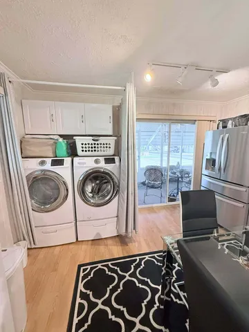 a utility room with sink dryer and washer
