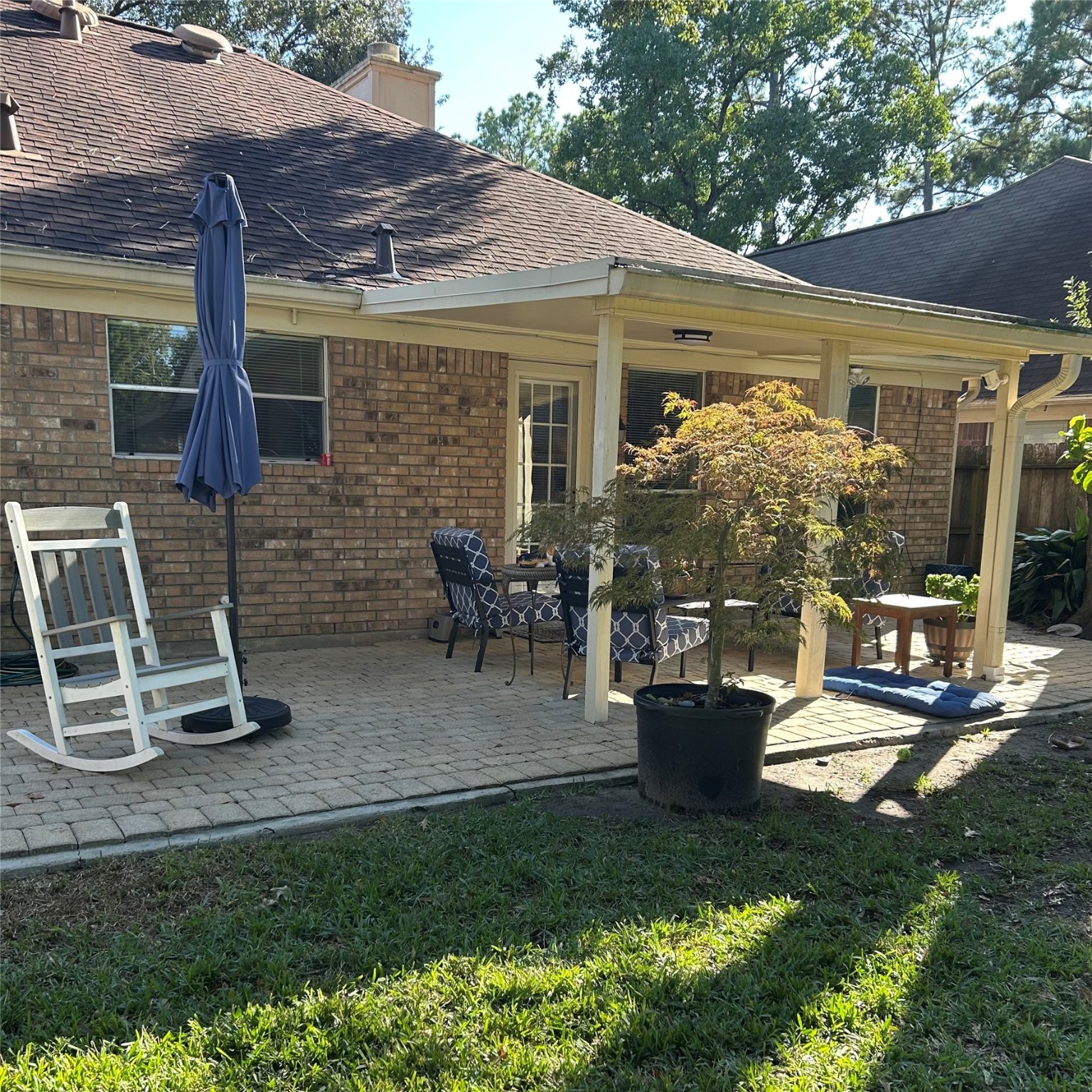 8910 Driftstone Drive Spring, TX 77379 - Photo 16 of 20 a view of a patio with table and chairs potted plants and floor to ceiling window