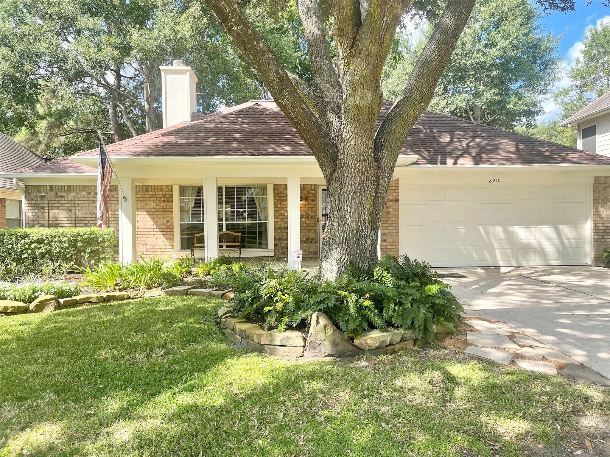 8910 Driftstone Drive Spring, TX 77379 - Photo 2 of 20 a front view of a house with a yard and potted plants