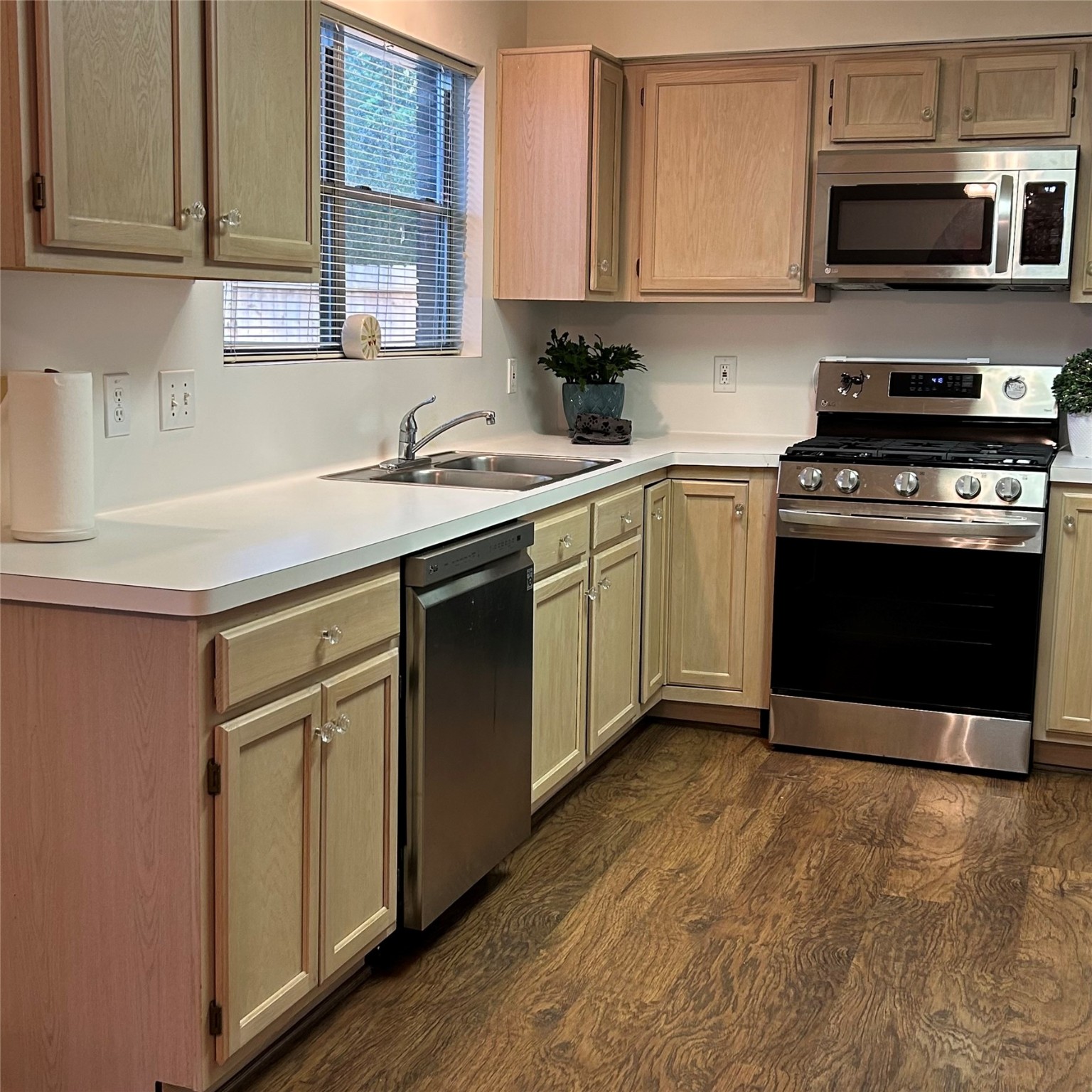 8910 Driftstone Drive Spring, TX 77379 - Photo 6 of 20 a kitchen with stainless steel appliances granite countertop a sink stove and microwave