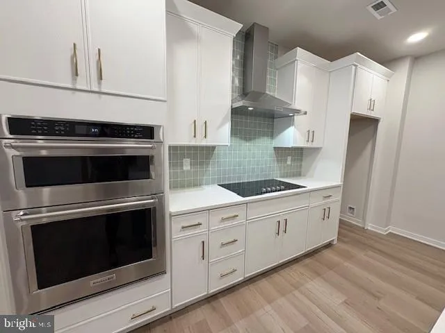 a kitchen with granite countertop white cabinets white stainless steel appliances and sink
