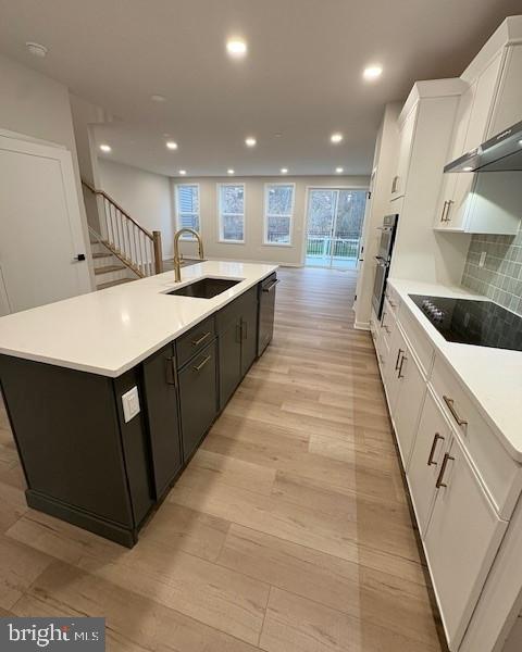 20 Grayson Lane Downingtown, PA 19335 - Photo 4 of 29 a large white kitchen with kitchen island a sink a counter top space and cabinets