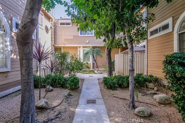 a view of a patio with plants and trees