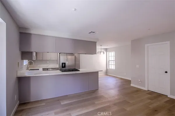 a kitchen with stainless steel appliances a sink stove and cabinets