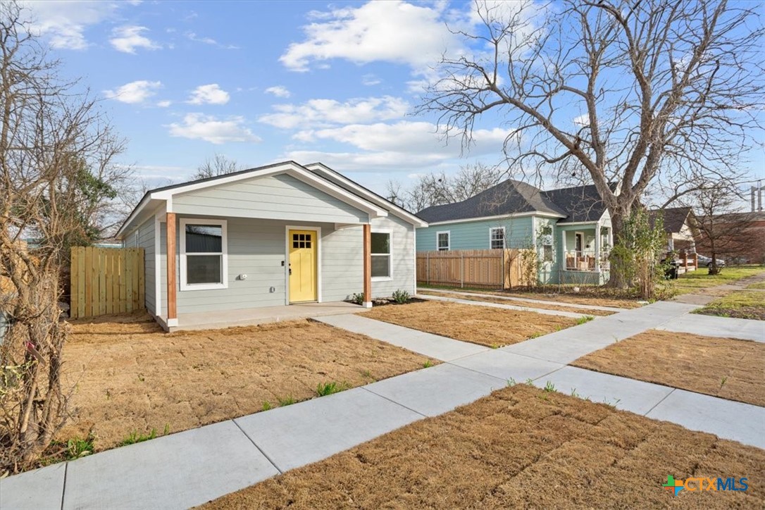 707 South 13th Street Temple, TX 76504 - Photo 2 of 24 a front view of a house with a yard and garage