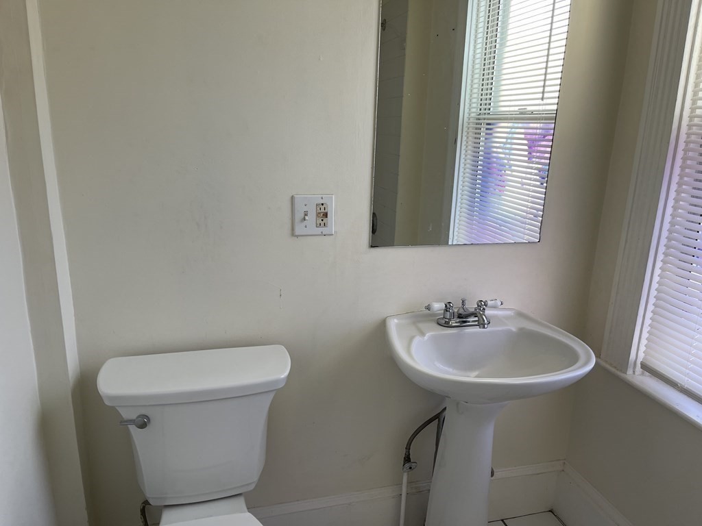 48 Hodges Avenue, Unit 2 Taunton, MA 02780 - Photo 11 of 11 a bathroom with a sink a toilet and mirror