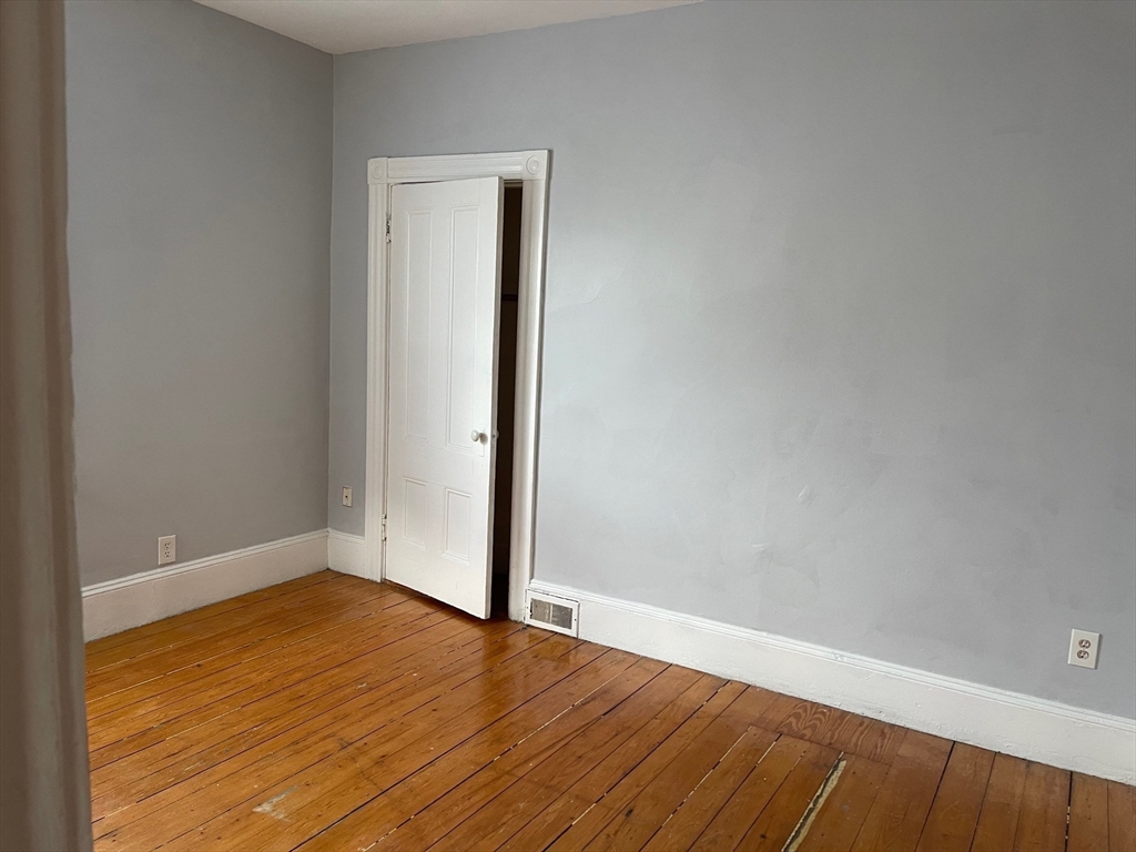 48 Hodges Avenue, Unit 2 Taunton, MA 02780 - Photo 6 of 11 a view of empty room with wooden floor