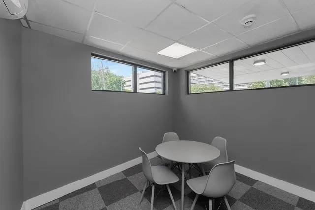 a view of a room with a table and chairs