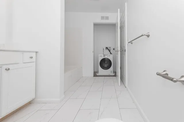 a bathroom with a bathtub and a toilet