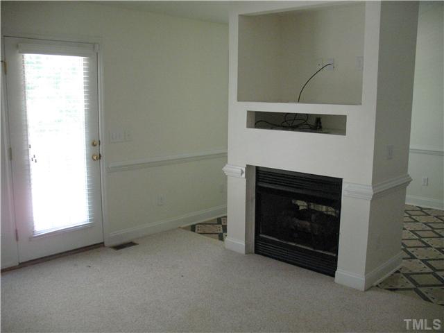 5701 Novaglen Road Durham, NC 27712 - Photo 3 of 12 a living room with a fireplace and a fireplace