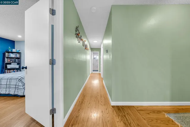 a view of a hallway with wooden floor