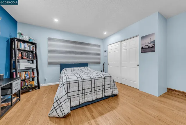 a bedroom with a bed and a book shelf