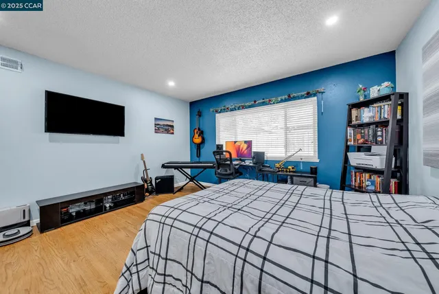 a bed room with a bed and a flat screen tv