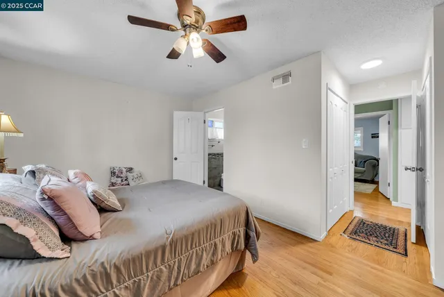 a bedroom with a large bed and a chandelier