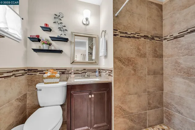 a bathroom with a sink a toilet and shower curtain