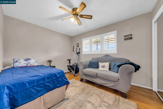 a bedroom with bed couch and window
