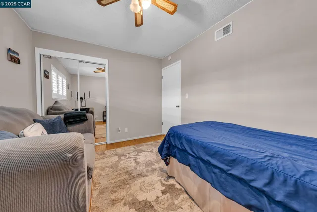 a living room with a bed and a chandelier