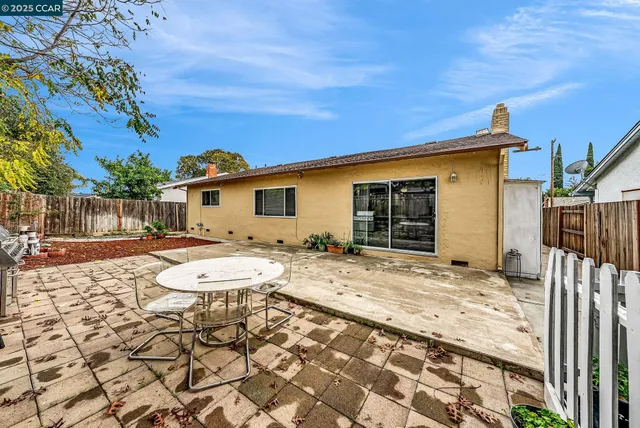 a view of a house with wooden fence