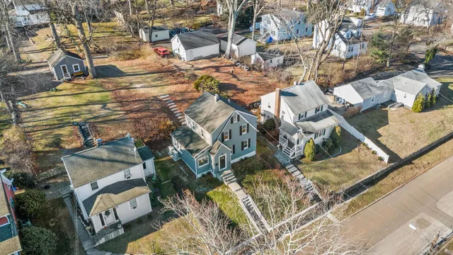 an aerial view of a house with a yard