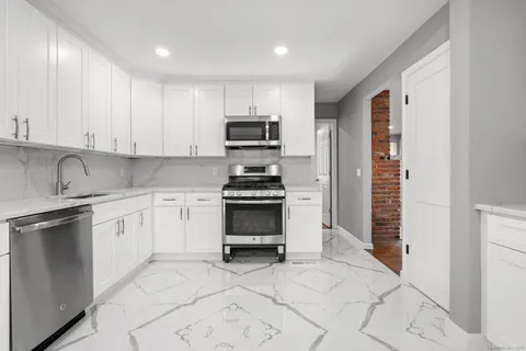 a kitchen with cabinets and stainless steel appliances