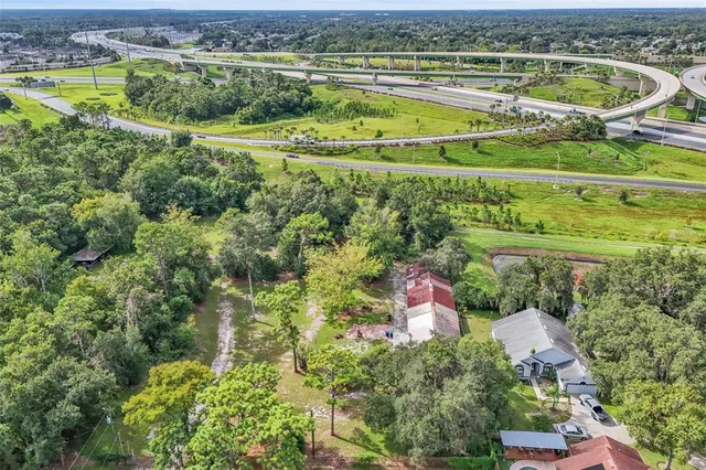 an aerial view of residential houses with outdoor space and city view