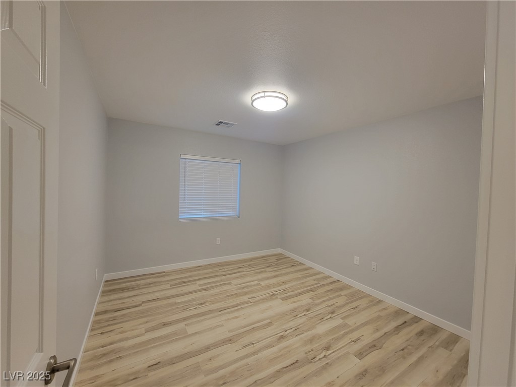 1021 East Manse Road Pahrump, NV 89048 - Photo 9 of 25 Empty room with light wood-type flooring and baseboards