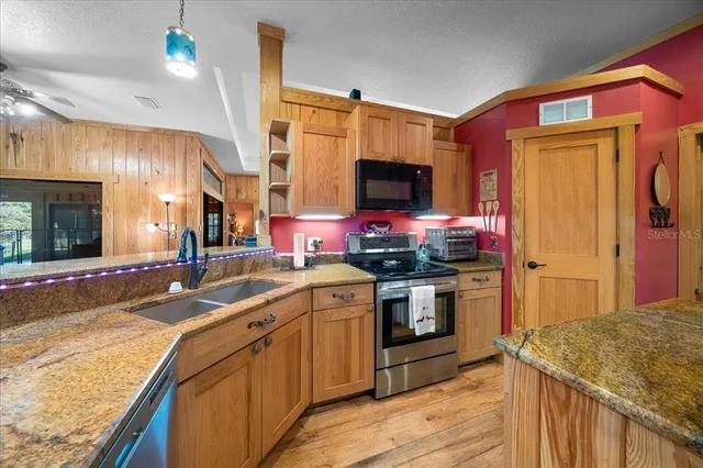 a spacious bedroom with a bed and a chandelier