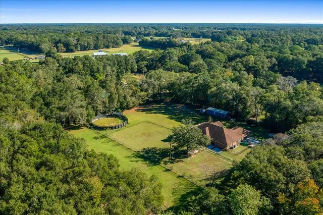 a kitchen with stainless steel appliances granite countertop a sink counter space cabinets and a fireplace