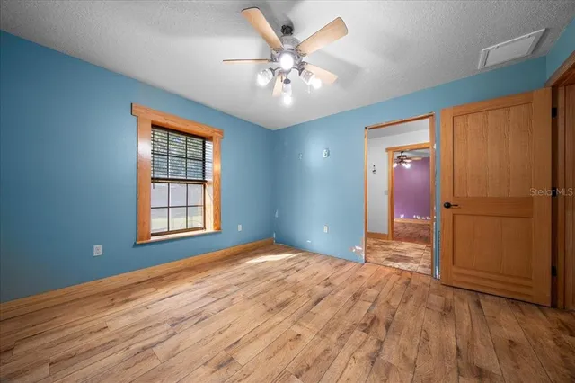 a view of a house with a big yard and large trees