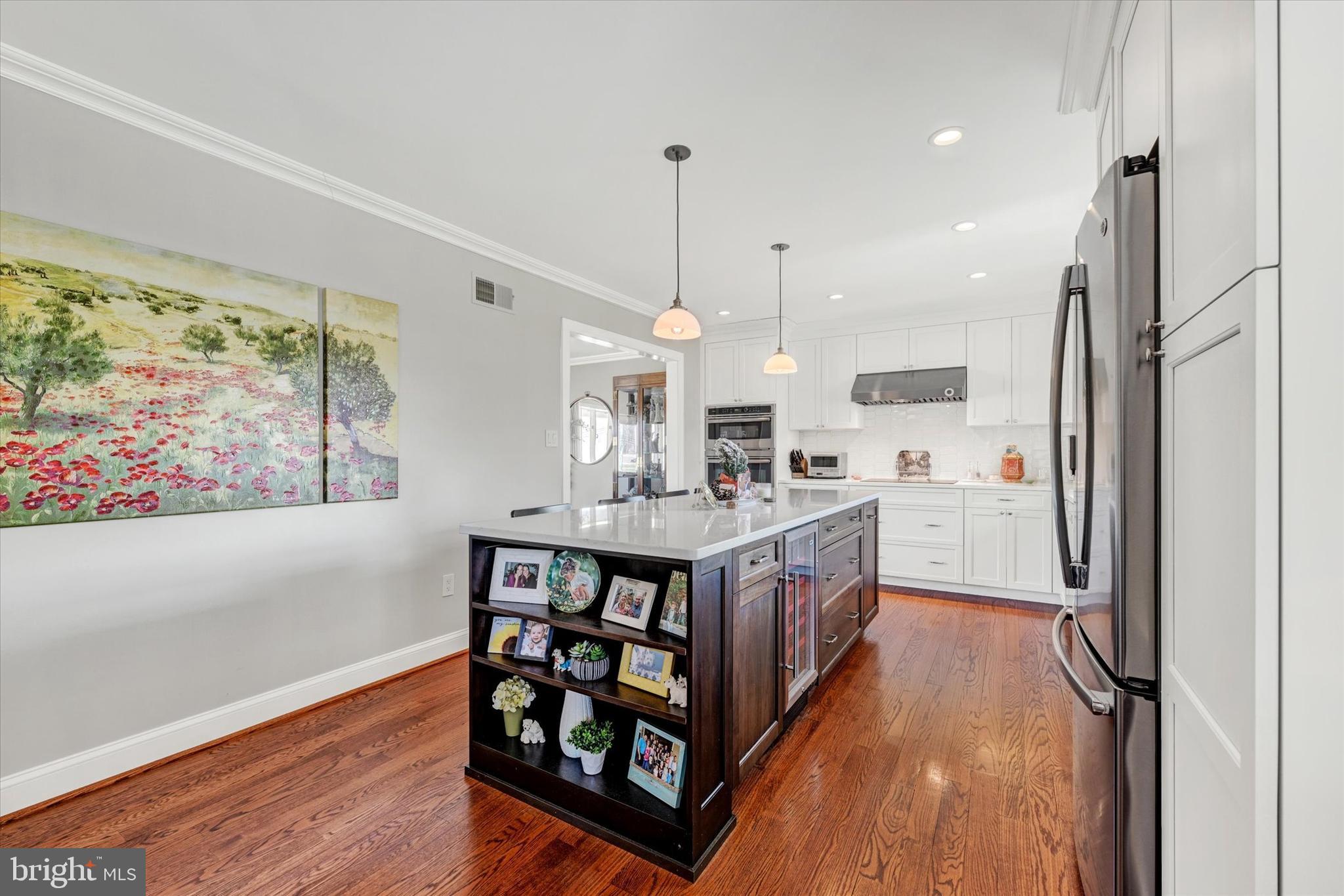 2211 Old Bosley Road Cockeysville, MD 21030 - Photo 14 of 65 a kitchen with stainless steel appliances granite countertop a refrigerator a sink dishwasher a stove and a dining table with wooden floor