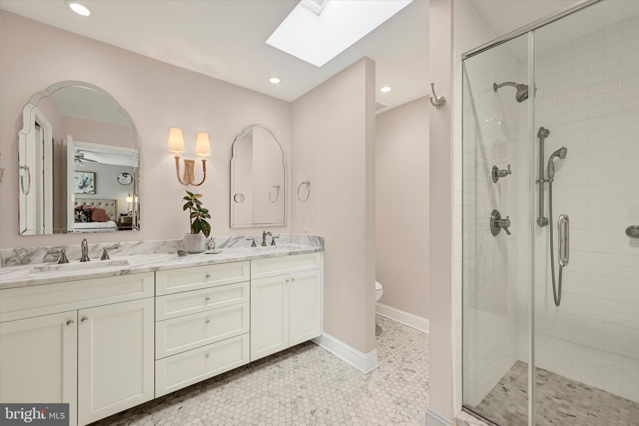 2211 Old Bosley Road Cockeysville, MD 21030 - Photo 19 of 65 a spacious bathroom with a double vanity sink mirror and shower