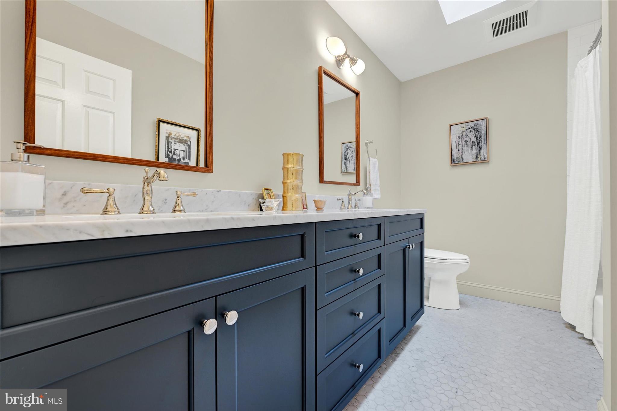 2211 Old Bosley Road Cockeysville, MD 21030 - Photo 22 of 65 a bathroom with a double vanity sink and a toilet