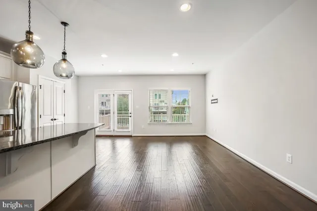 a view of a room with wooden floor and windows